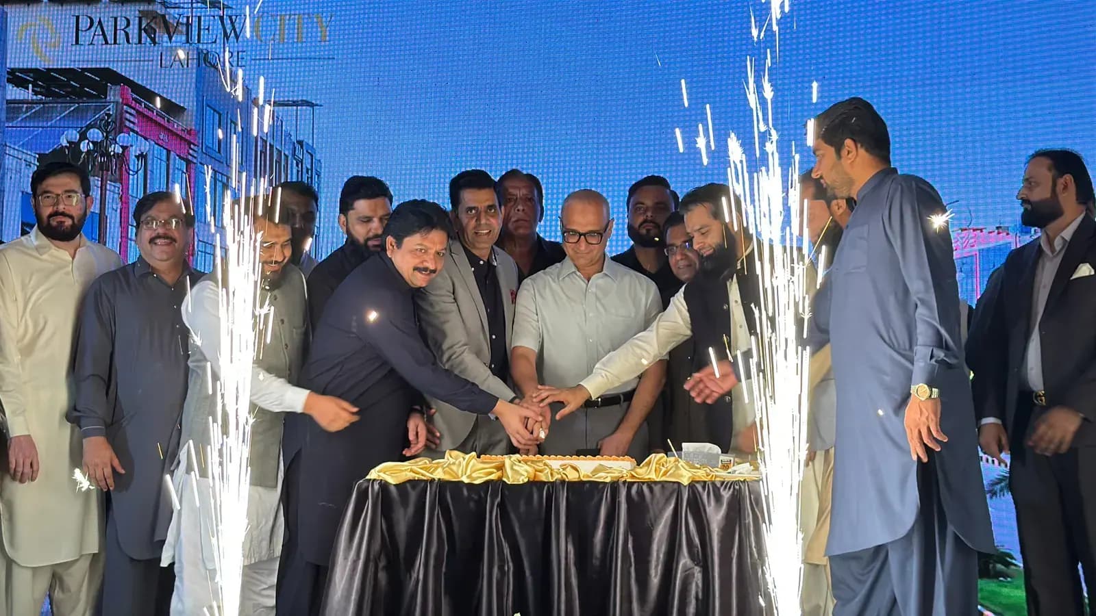 Cake-cutting with sparklers at a Broadway project ground-breaking.