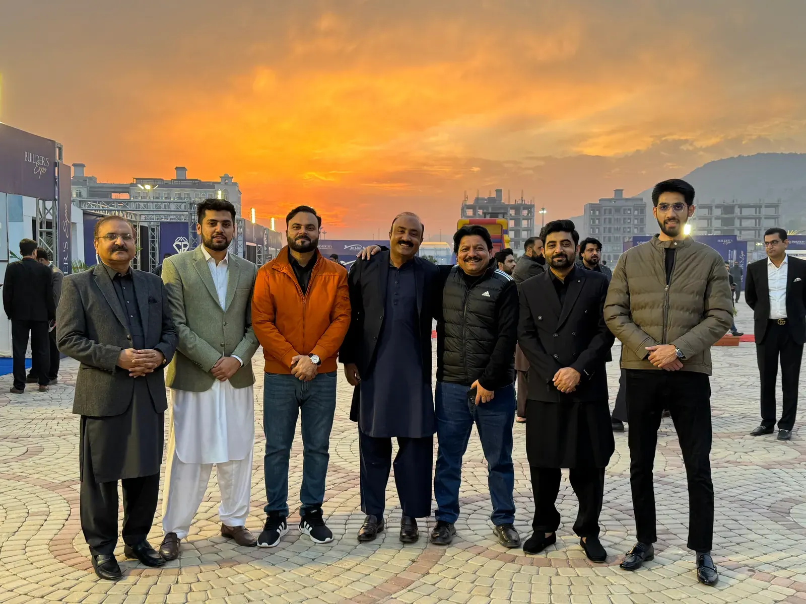 PropertyInn team on a project site at dusk.